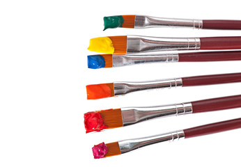 paint brushes with paint on white background