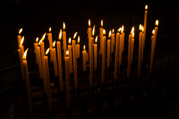 Church candle in a row.  Closeup of burning candle