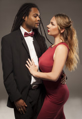 cute young mixed couple against black