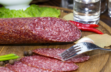 sausages on a wooden plate with vegetables in a restaurant