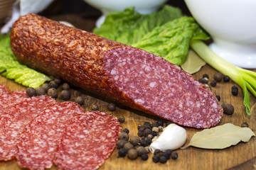 sausages on a wooden plate with vegetables in a restaurant