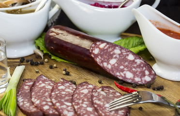 sausages on a wooden plate with vegetables in a restaurant