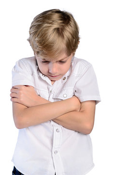 upset young boy with crossed arms