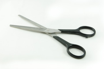 Barber scissors with plastic handles isolated over white