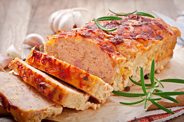 Homemade ground meatloaf with ketchup and rosemary