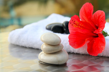 red Hibiscus flower with towel and zen  in spa