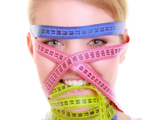 Obsessed fitness woman with a lot of colorful measure tapes