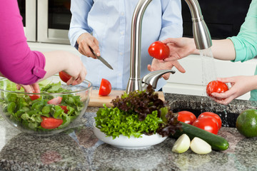 Group of women preparing food in kitchen