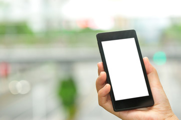 woman hand hold smart phone in modern city 