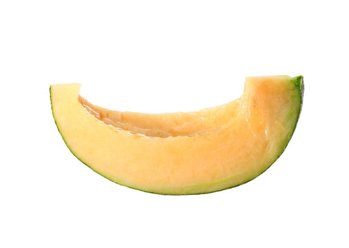 Cantaloupe melon cut into slices isolated on white.