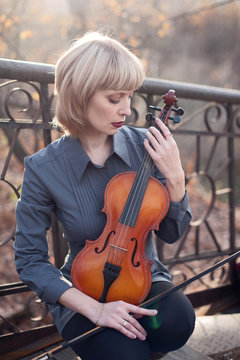 Mature Woman With Viola On The Bridge