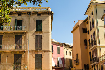 Fototapeta na wymiar Old yellow residential houses in downtown Palma de Mallorca
