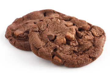 Two dark large chocolate chip cookies on white - obrazy, fototapety, plakaty