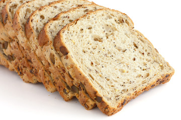 Slices of multi-seed whole-wheat bread on white surface