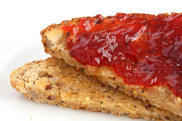 Multi-seed wholegrain bread toasted and buttered with jam