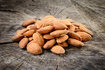 Almonds on wooden background