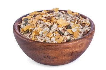 Selbstklebende Fototapeten Healthy muesli from different grains in a wooden bowl © DDsign
