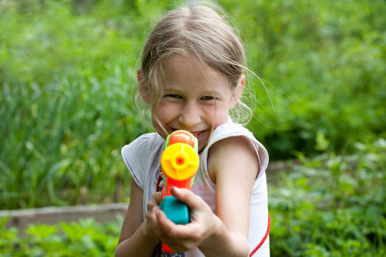 Small Girl With Toy Water Gun