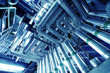 Equipment, cables and piping as found inside of a modern industr