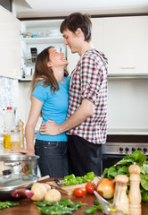  loving couple flirting  in  kitchen