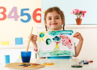 Little girl shows her painting