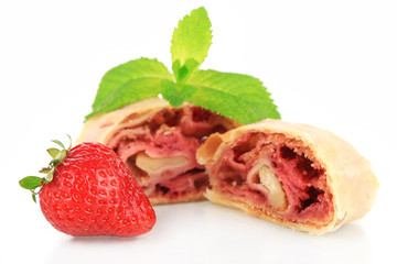 Tasty homemade strudel with fresh strawberry and mint leaves