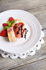 Tasty homemade strudel with ice-cream, fresh strawberry and