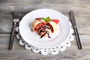 Tasty homemade strudel with ice-cream, fresh strawberry and