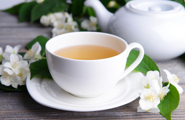 Fototapeta na wymiar Cup of tea with jasmine on table close-up