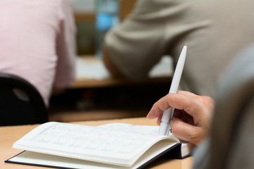 Close-up of a female hand with a pen.