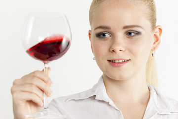 portrait of young woman with a glass of red wine