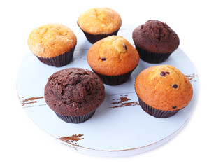 Tasty muffins on wooden tray isolated on white