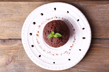 Chocolate muffin on plate wooden background