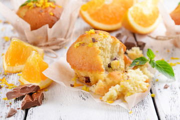 Tasty cupcakes with orange on table close-up