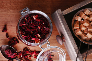 Dried hibiscus tea in glass jar, brown sugar  in box