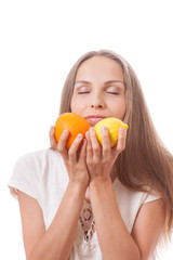 young woman holding orange and lemon