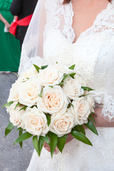 Wedding roses in hands of bride, close-up view