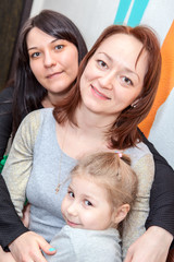 Three happy sisters different ages are together