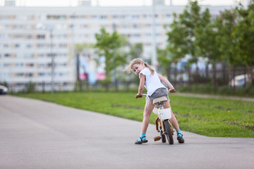 Little girl looking back when sitting bicycle