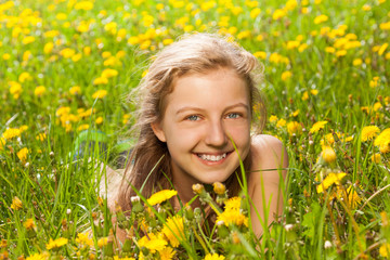 Portrait of beautiful girl in the green grass
