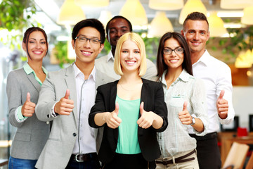 Smiling business group giving thumbs up