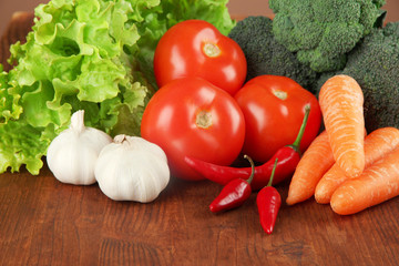Composition of different vegetables on wooden background