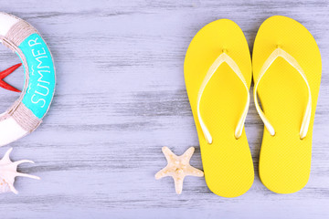 Bright flip-flops on color wooden background