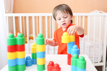 baby playing constructor at home