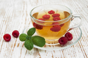 Cup of tea with raspberry