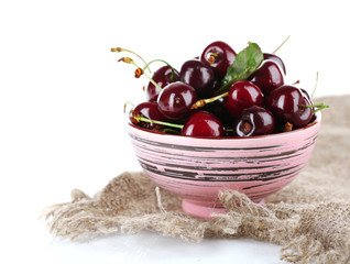 Sweet cherries in color bowl isolated on white