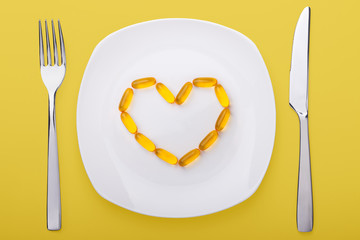 fish oil soft gels lying on a plate