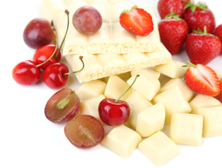 White chopped chocolate bar with fresh berries, isolated