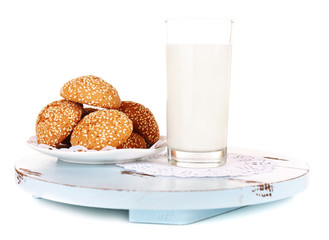 Milk and cookies on wooden tray isolated on white