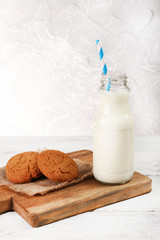 Milk and cookies on table on grey background